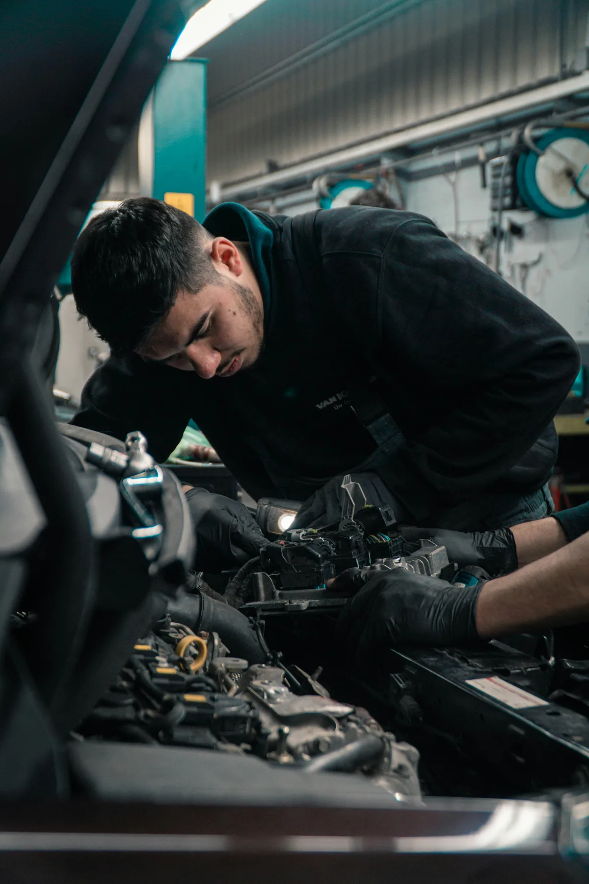 Automotive technician inspecting a vehicle component
